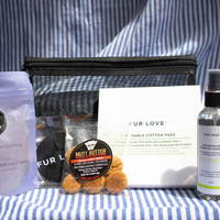 Fur Love Summer Set with micellar cleansing spritz, paw and body salt soak, cooling bandana, treats and reusable cotton pads displayed in front of the limited edition Fur Love bag